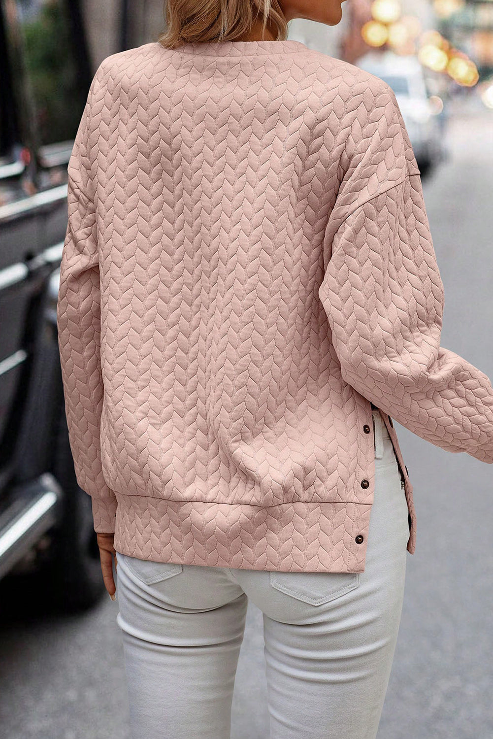 Schwarzer gesteppter Sweatshirt mit Druckknopfdetails und überschnittenen Schultern