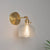 Eisen Messing-Finish Wandleselampe Schwenkarm 1-Licht Industrielle Wandmontierte Lampe mit Blüte/Schale Klarglas-Schirm