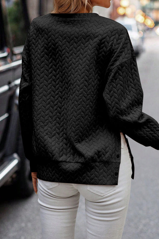 Schwarzer gesteppter Sweatshirt mit Druckknopfdetails und überschnittenen Schultern